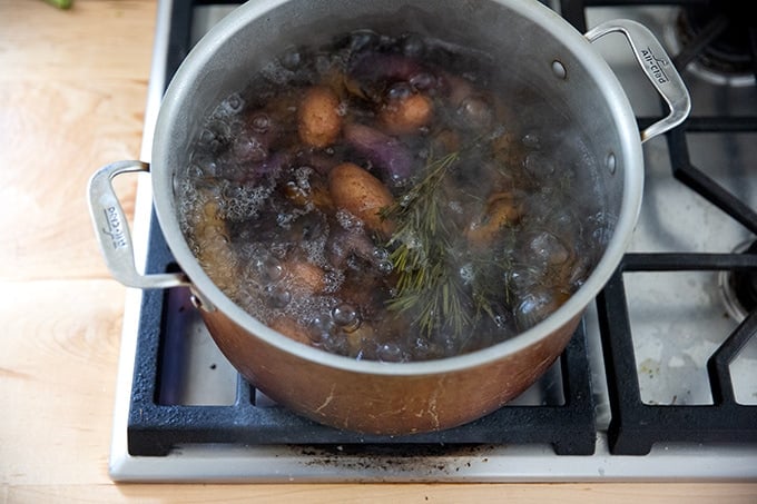 A pot of potatoes boiling on the stovetop.