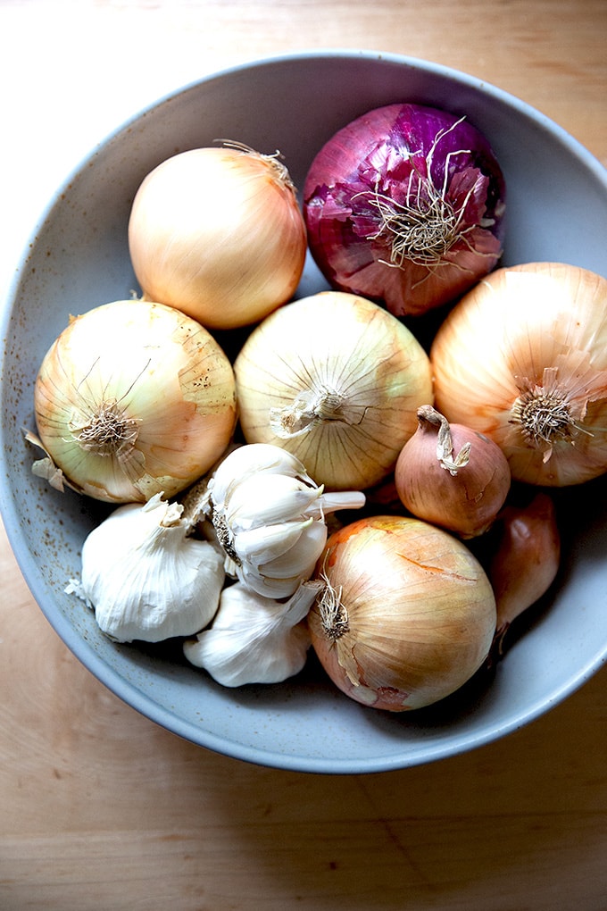 A bowl filled with onions and garlic.