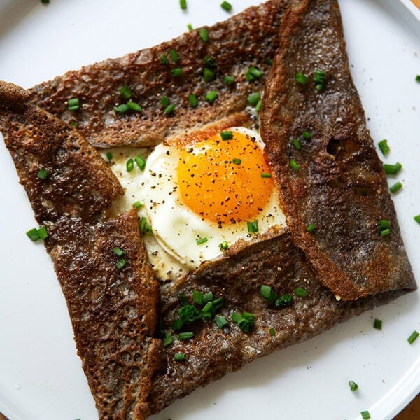 A plate topped with an egg-and-gruyere filled buckwheat crepe.