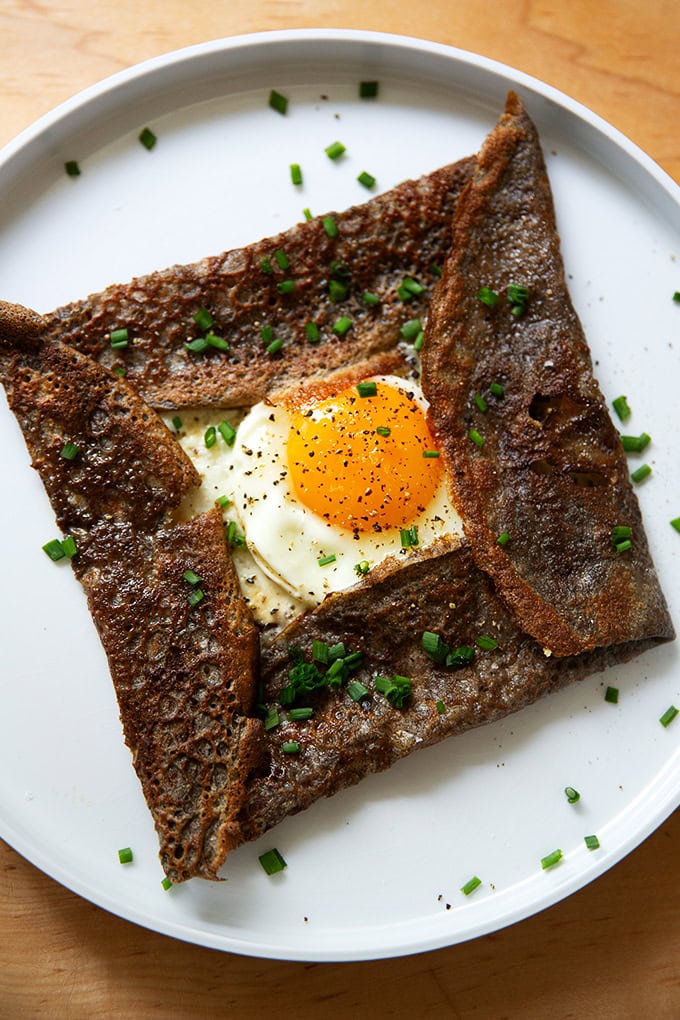 A plate topped with an egg-and-gruyere filled buckwheat crepe.