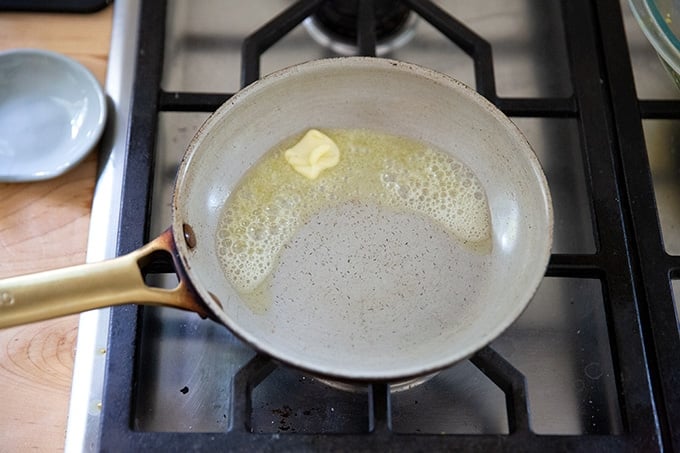 A skillet with melted butter. 