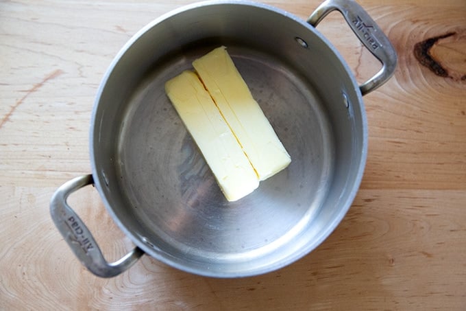 Two sticks of butter in a pot.