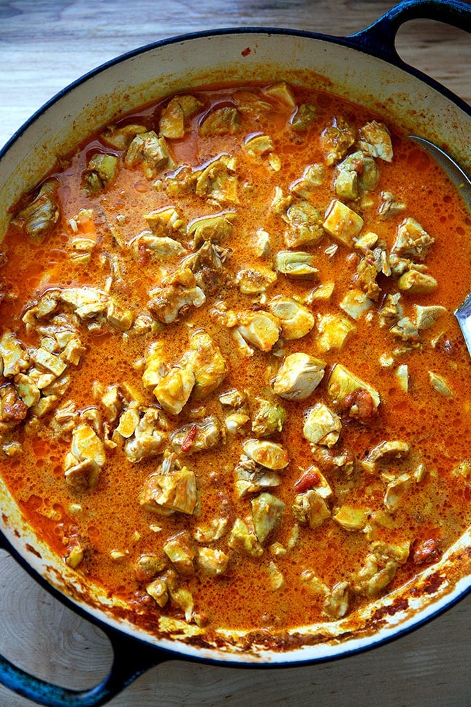 A large braiser filled with cooked butter chicken.