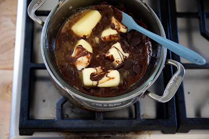 A double boiler with butter and chocolate melting in it.