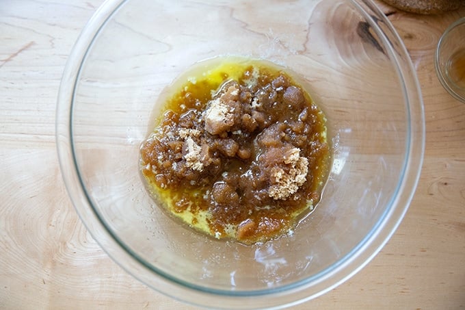 A bowl holding melted butter, brown sugar, and vanilla.