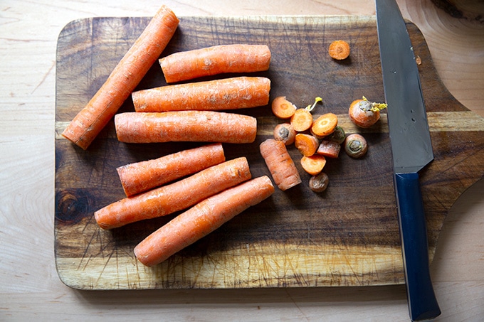 Carrots trimmed on a cutting board.