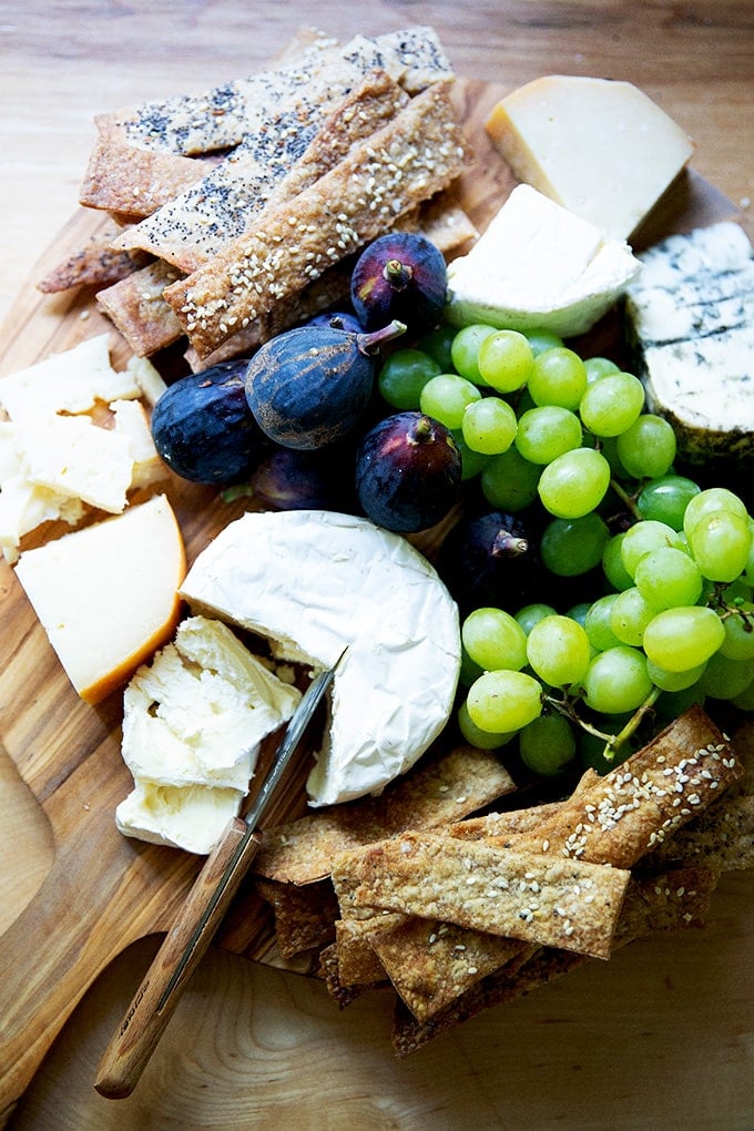 A cheese board with homemade sourdough crackers on it.