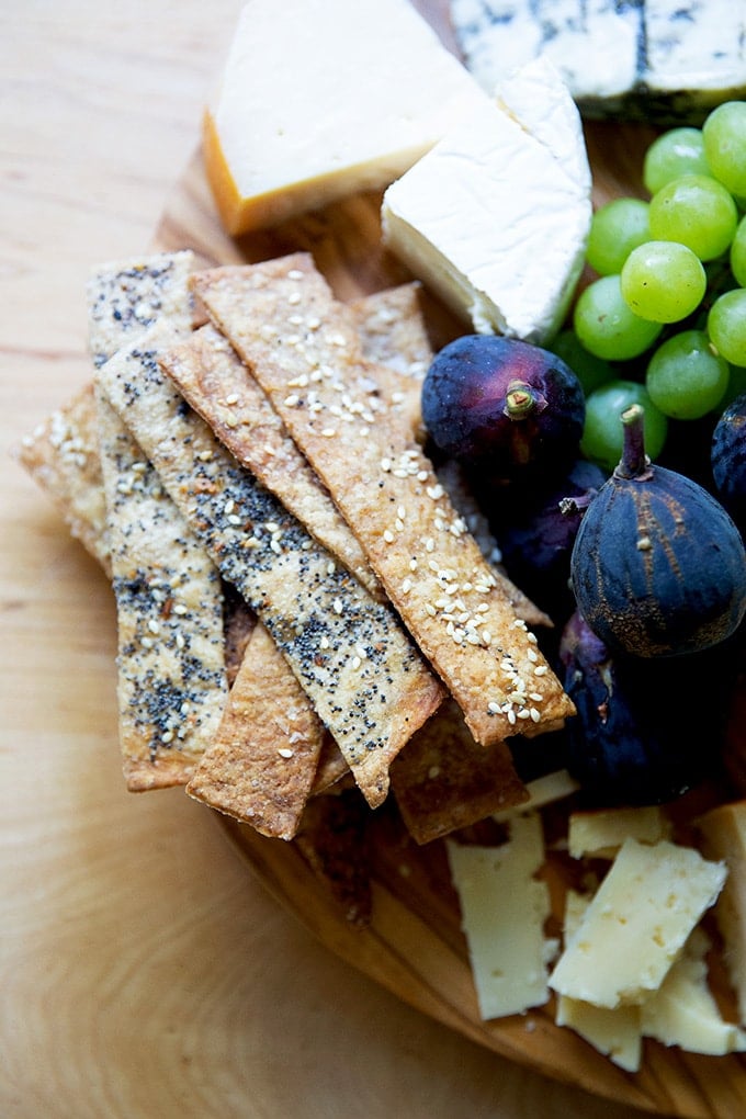 A cheese board with homemade sourdough crackers on it.