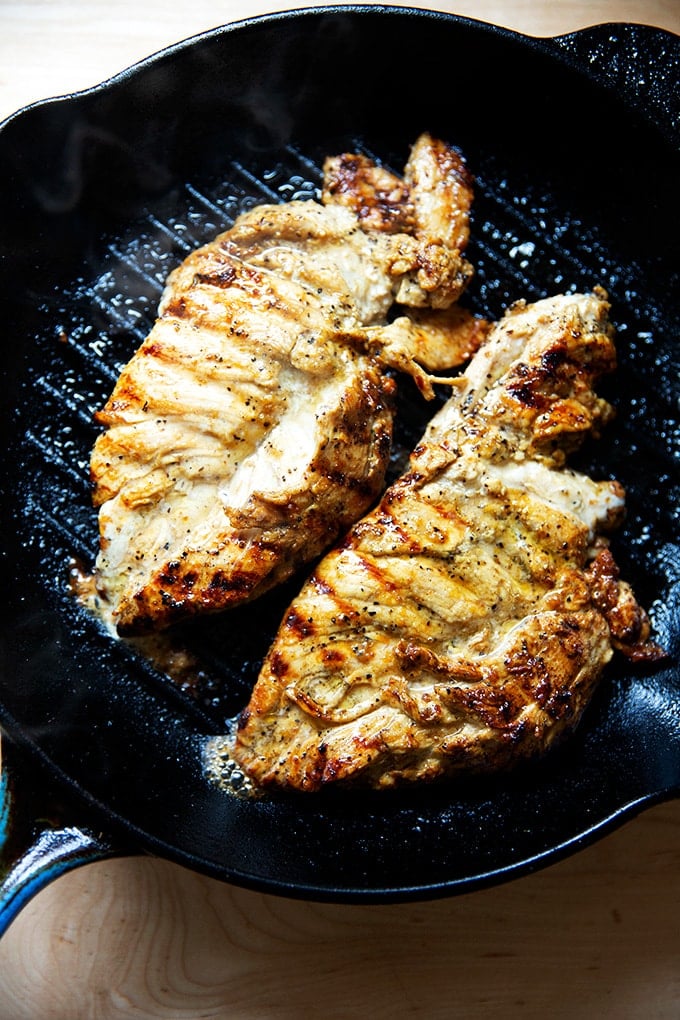 Grilled chicken breasts in a grill pan.
