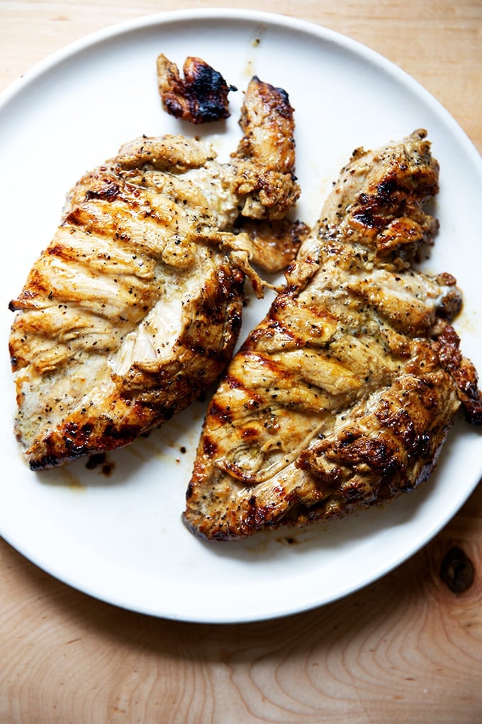 Grilled chicken breasts on a plate.