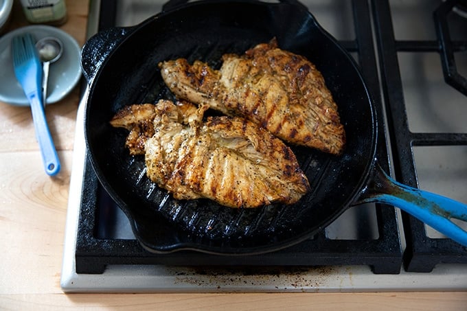 Grilled chicken breasts in a grill pan.