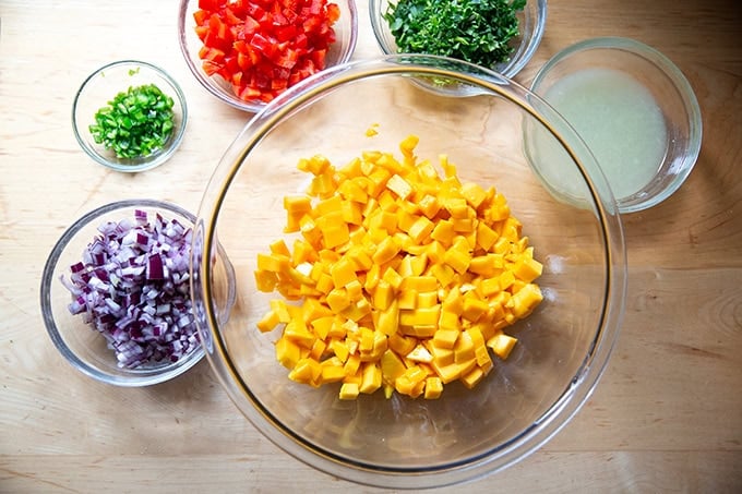 The ingredients to make mango salsa on a counter top. - 17