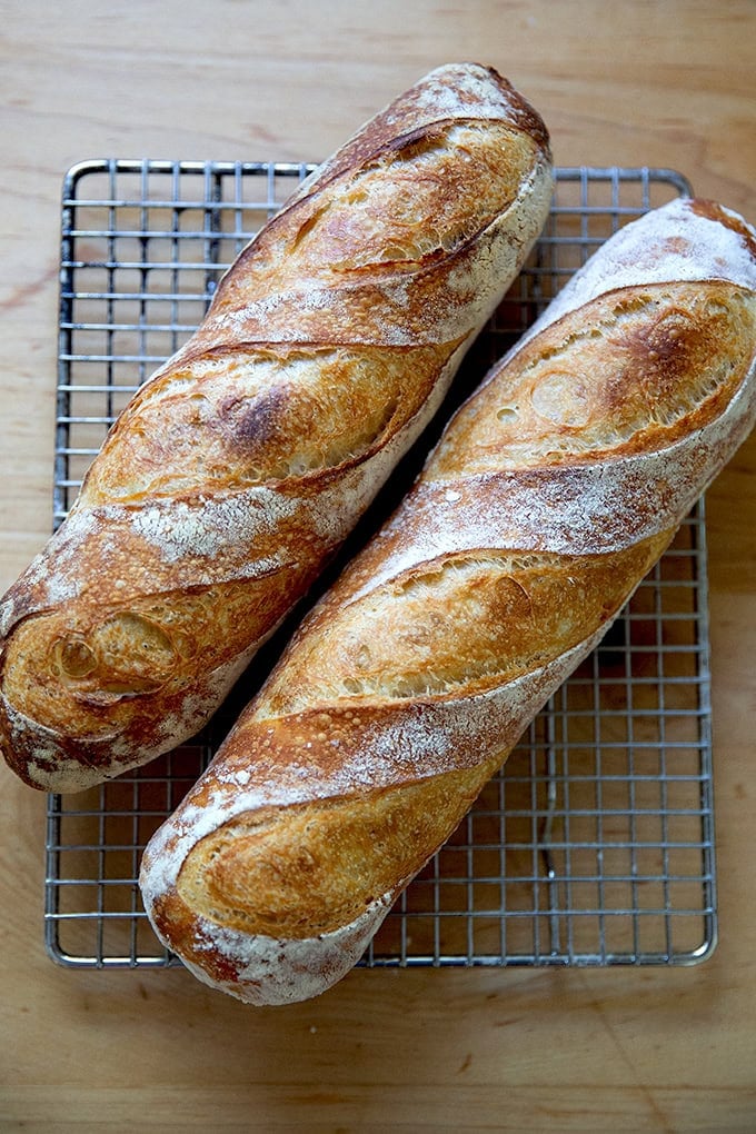 Two baguettes on a cooling rack.