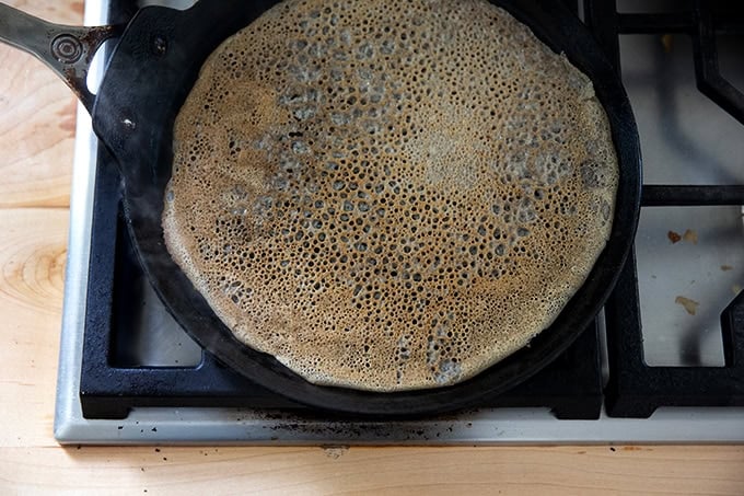 A nonstick skillet filled with a finished buckwheat crepe.