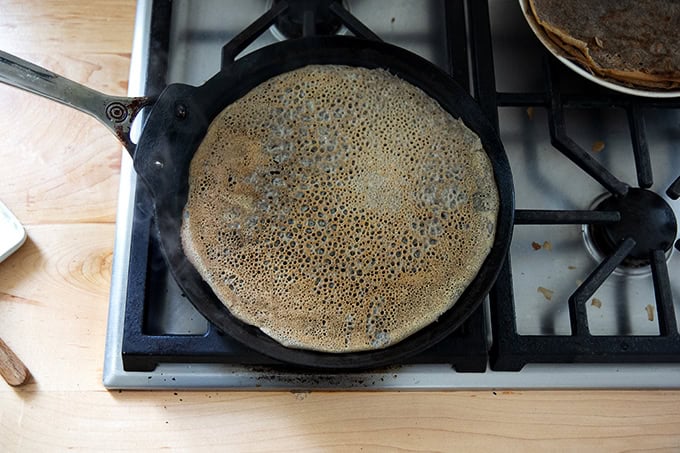 A nonstick skillet filled with a finished buckwheat crepe.