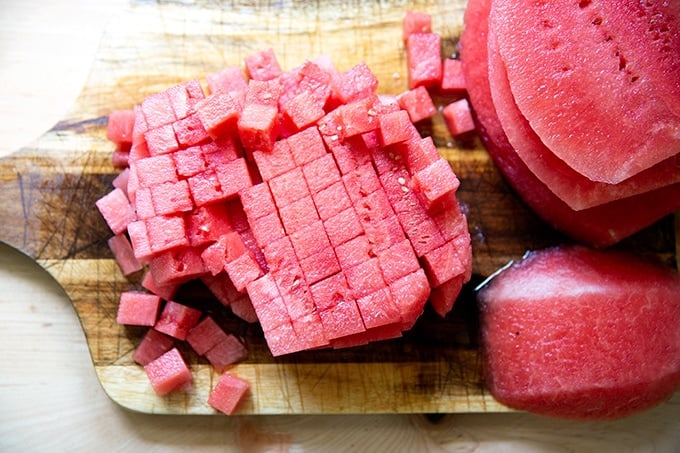 Cubed watermelon on a board.
