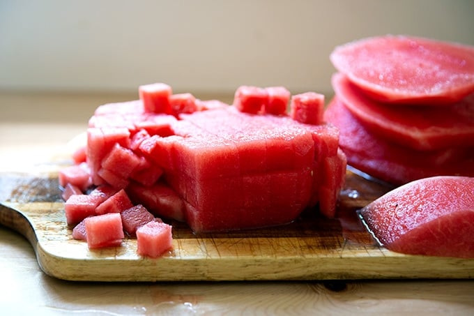 Cubed watermelon on a board.