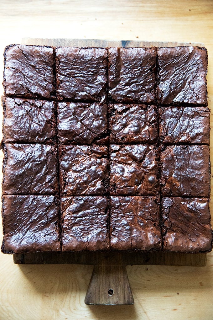 Just baked and cut brownies on a board.