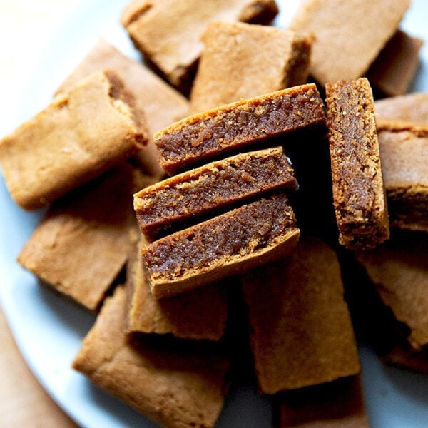 Cut gingerbread cookie bars on a plate.