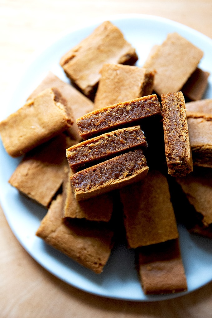Cut gingerbread cookie bars on a plate.