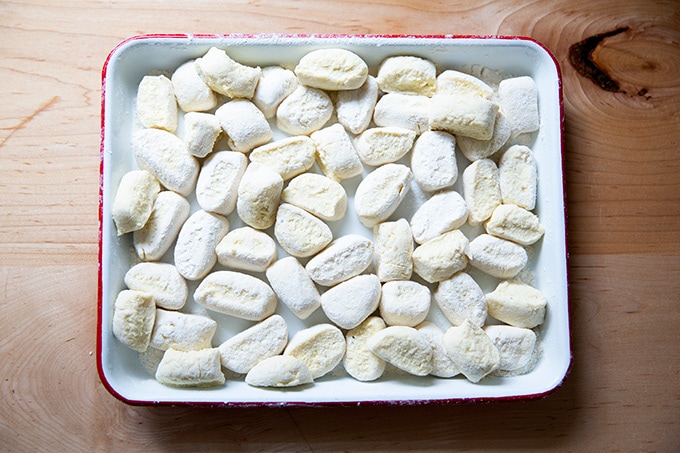 Cut ricotta gnocchi on a small sheet pan.