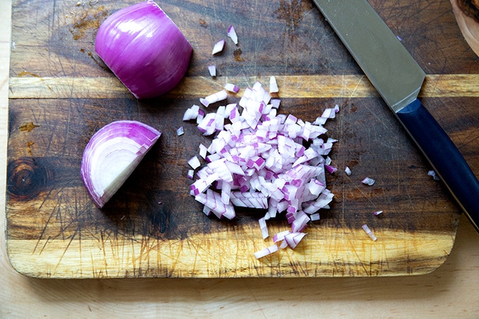A board holding finely diced red onion.