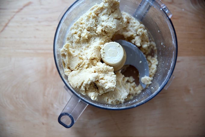 A food processor filled with lemon-almond snowball cookie dough. 