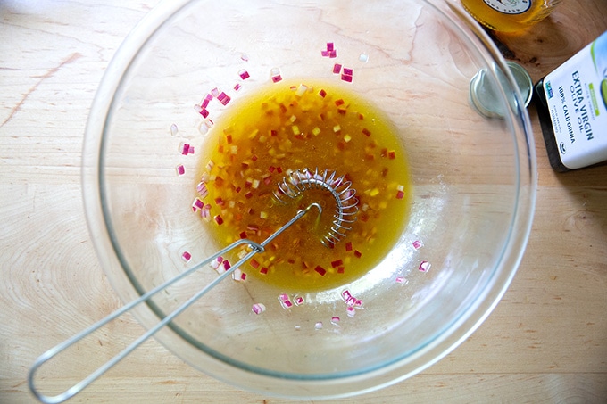 Red wine vinaigrette whisked together in a bowl.