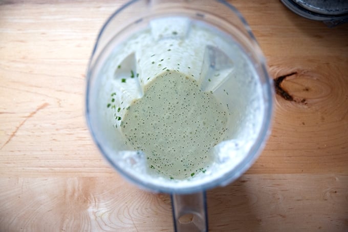 Blended vegan ranch dressing with chives in a Vitamix