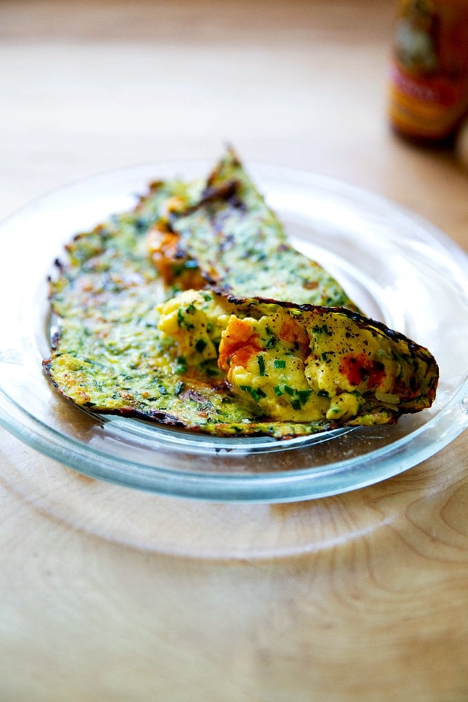 A breakfast taco made with a zucchini tortilla.