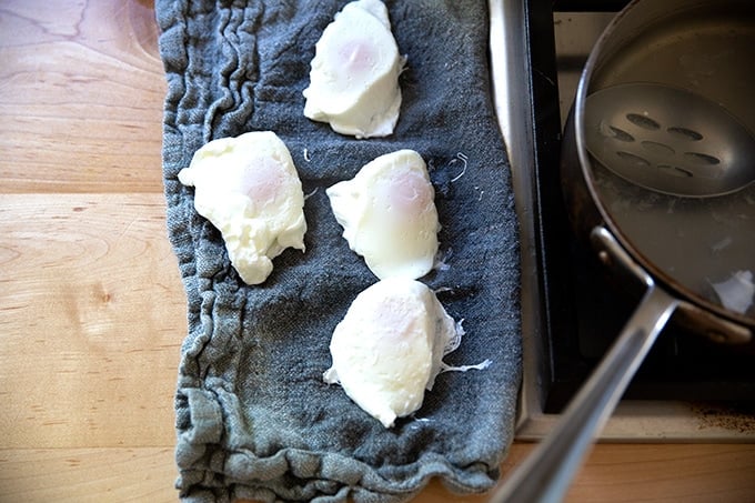 Four poached eggs on a napkin.