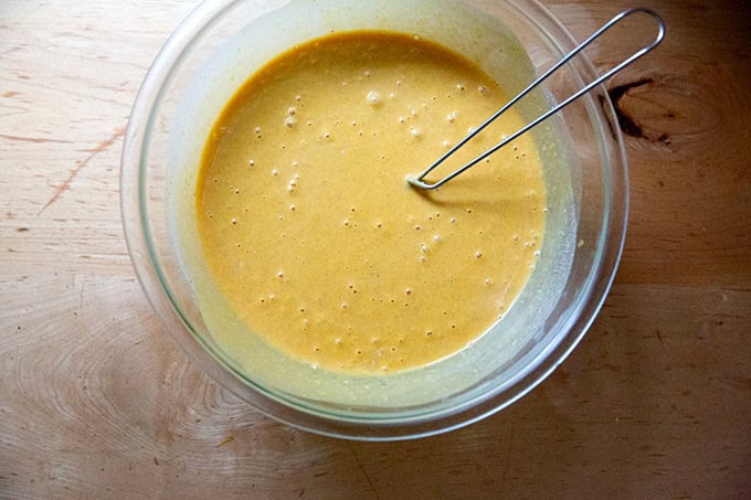The filling for butternut squash pie whisked together in a large bowl. - 11