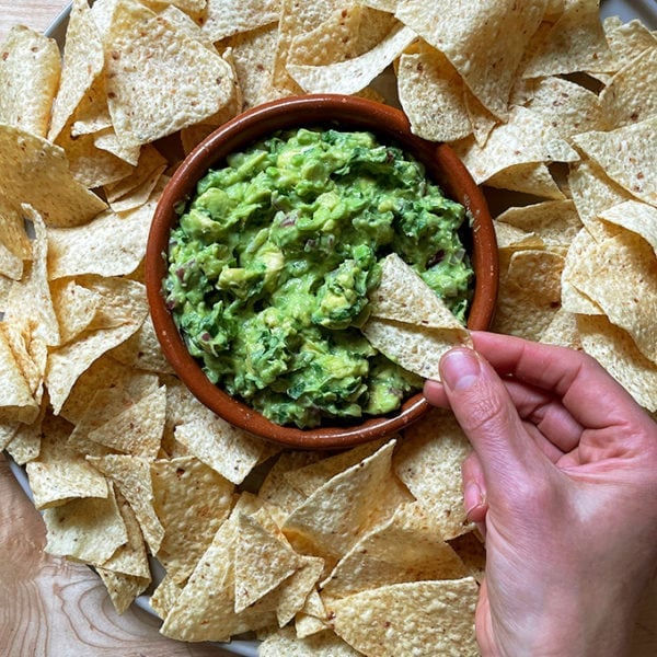 A platter of chips and guacamole.