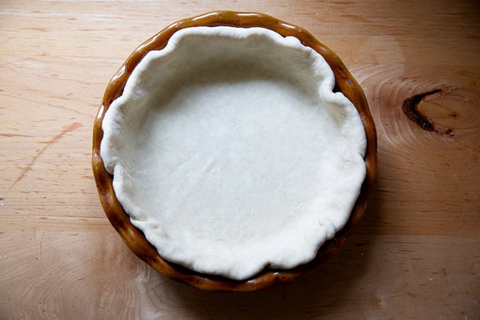 A pie plate fitted with pie dough. - 8