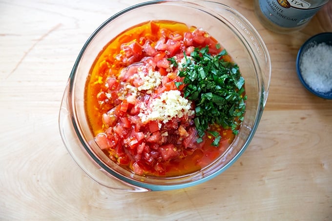 A bowl filled with the ingredients to make homemade bruschetta sauce.