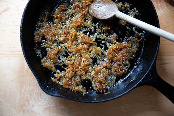 Shallots beginning to caramelize in a skillet.