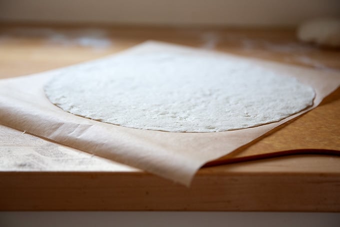 Rolled out gluten-free pizza dough on a peel.