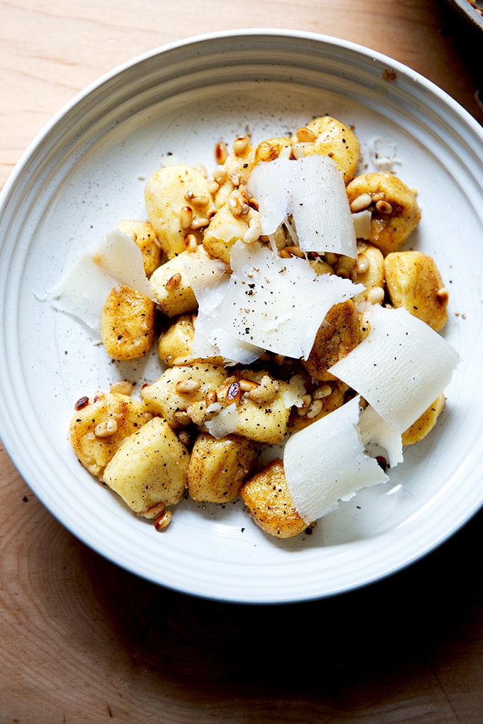 A bowl of brown butter gnocchi tossed with toasted pine nuts and parmesan.