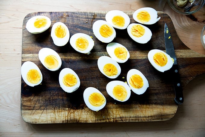 A board topped with halved hard-cooked eggs.