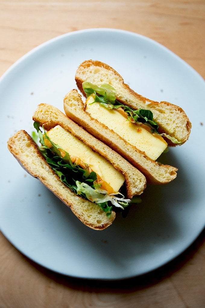 Brioche egg sandwich on a plate.