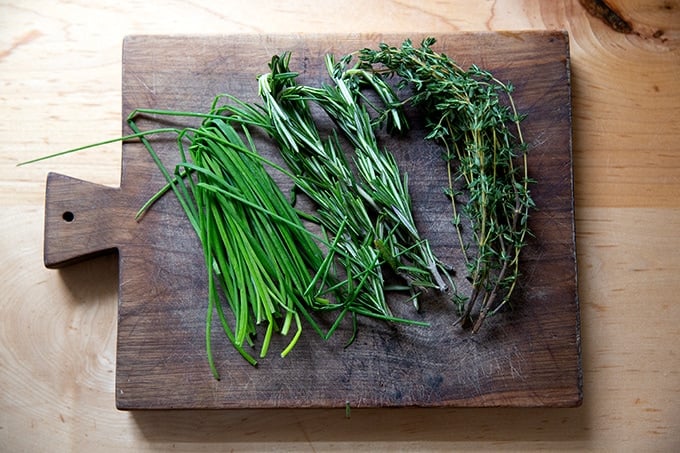 Herbs on a cutting board.