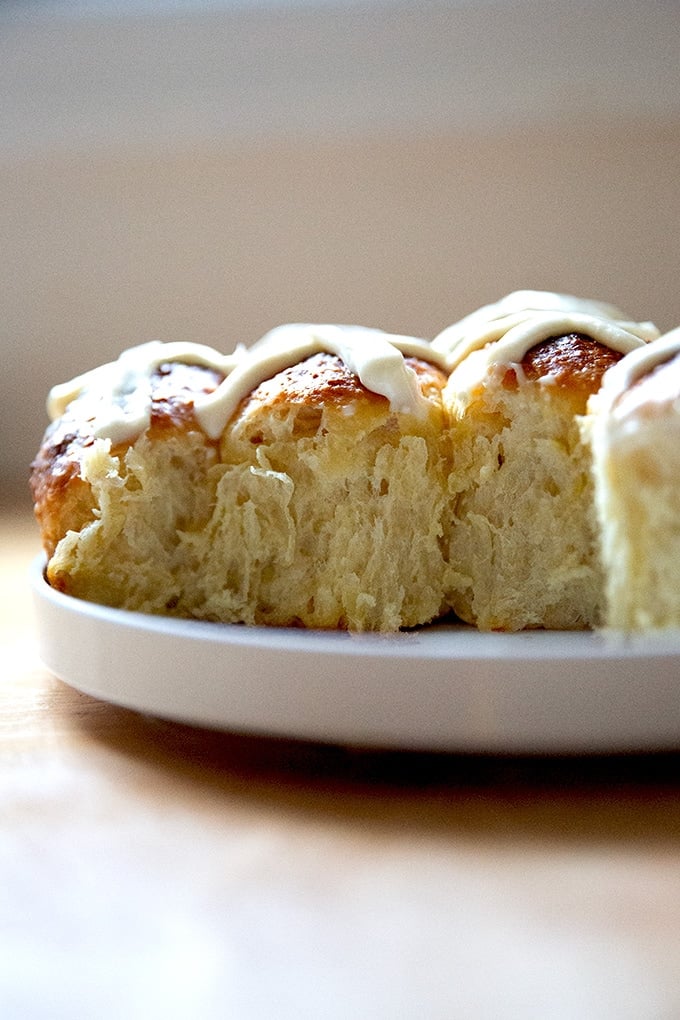 A cross section of hot cross buns in their baking dish.