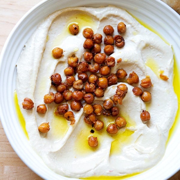 A platter of homemade hummus topped with crispy chickpeas.