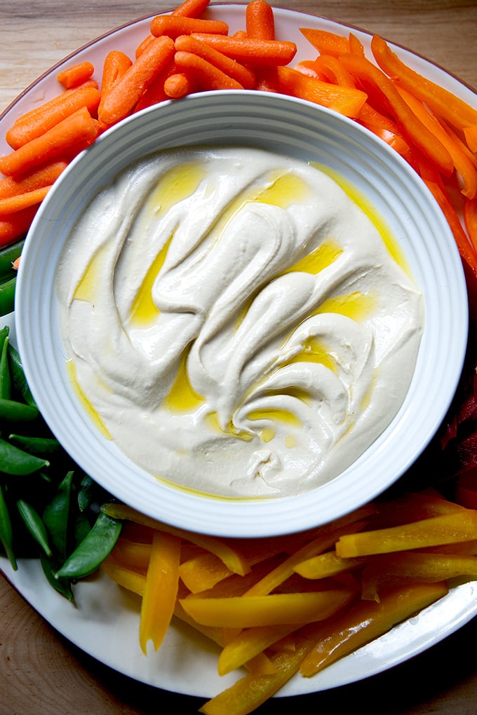 A platter of hummus and vegetables.