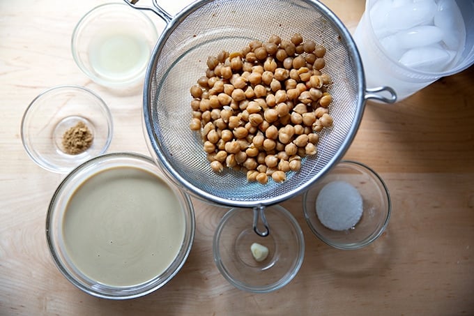 The ingredients to make hummus on a countertop.