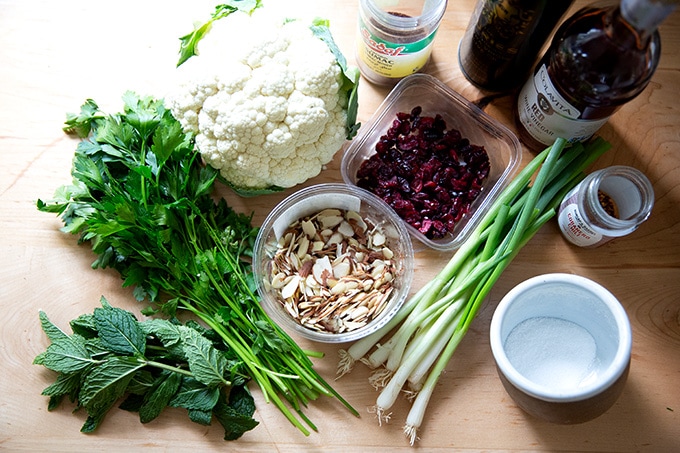 Ingredients to make cauliflower couscous salad on a countertop.