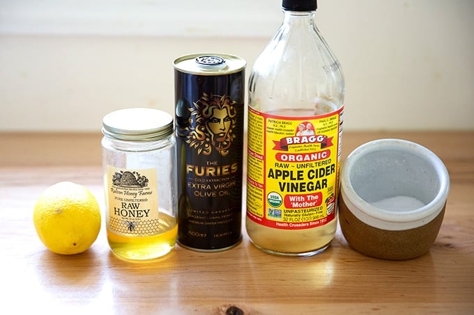 Ingredients to make apple cider vinaigrette on a counter.