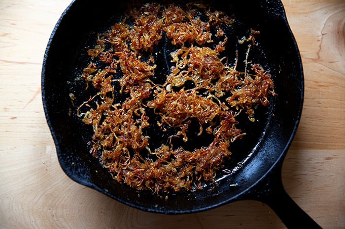 Crispy fried shallots in a skillet.