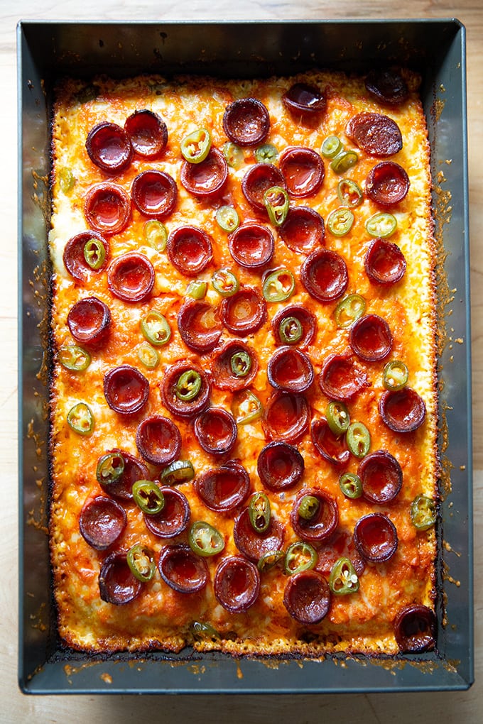 Just baked Detroit-style pizza topped with pepperoni and pickled jalapeños in the pan.