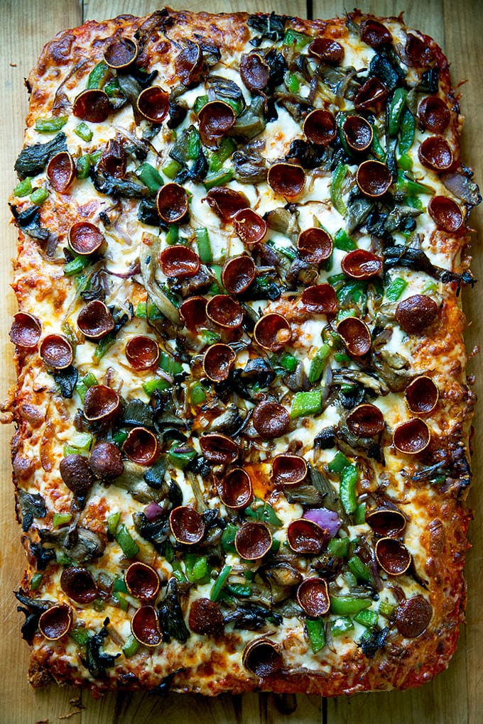 Just-baked Sicilian-style pizza on a cutting board.